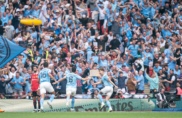 Manchester City players and supporters pictured celebrating a goal during their 2-1 win over Manchester United in the 2023 FA Cup final at Wembley